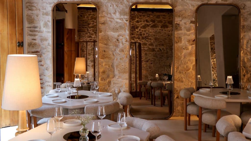 The dining room at Casona Café Bar, with stone walls and warm lamps